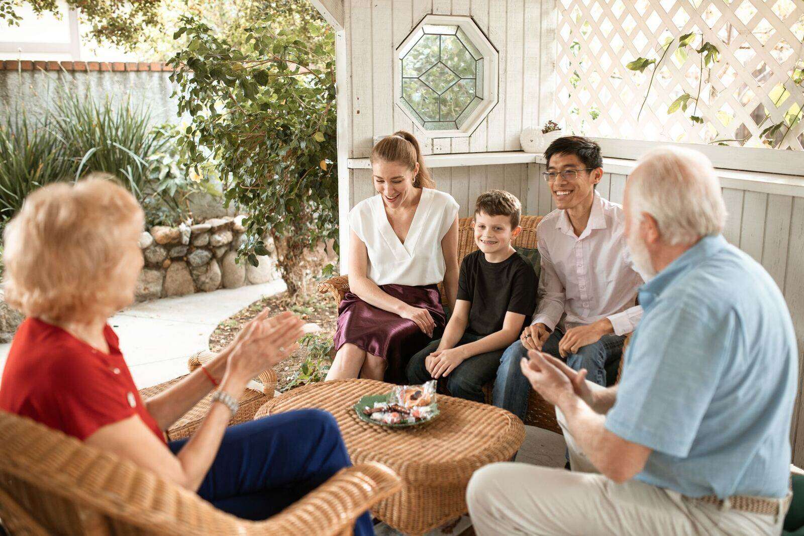 Three generations of a family sitting together outdoors