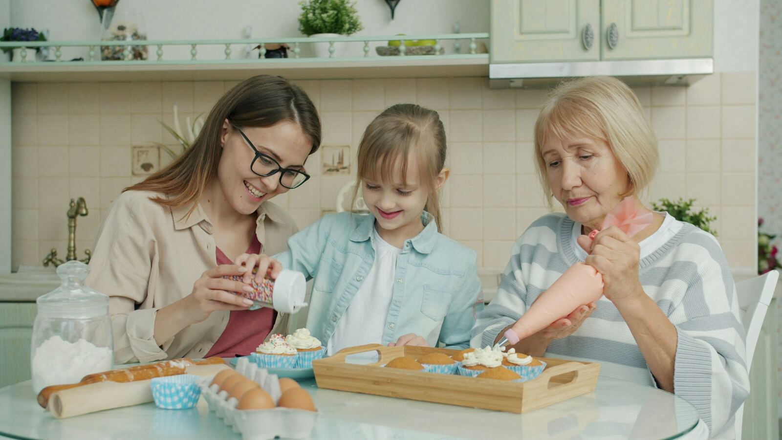 A mother, child and grandmother baking together in a kitchen
